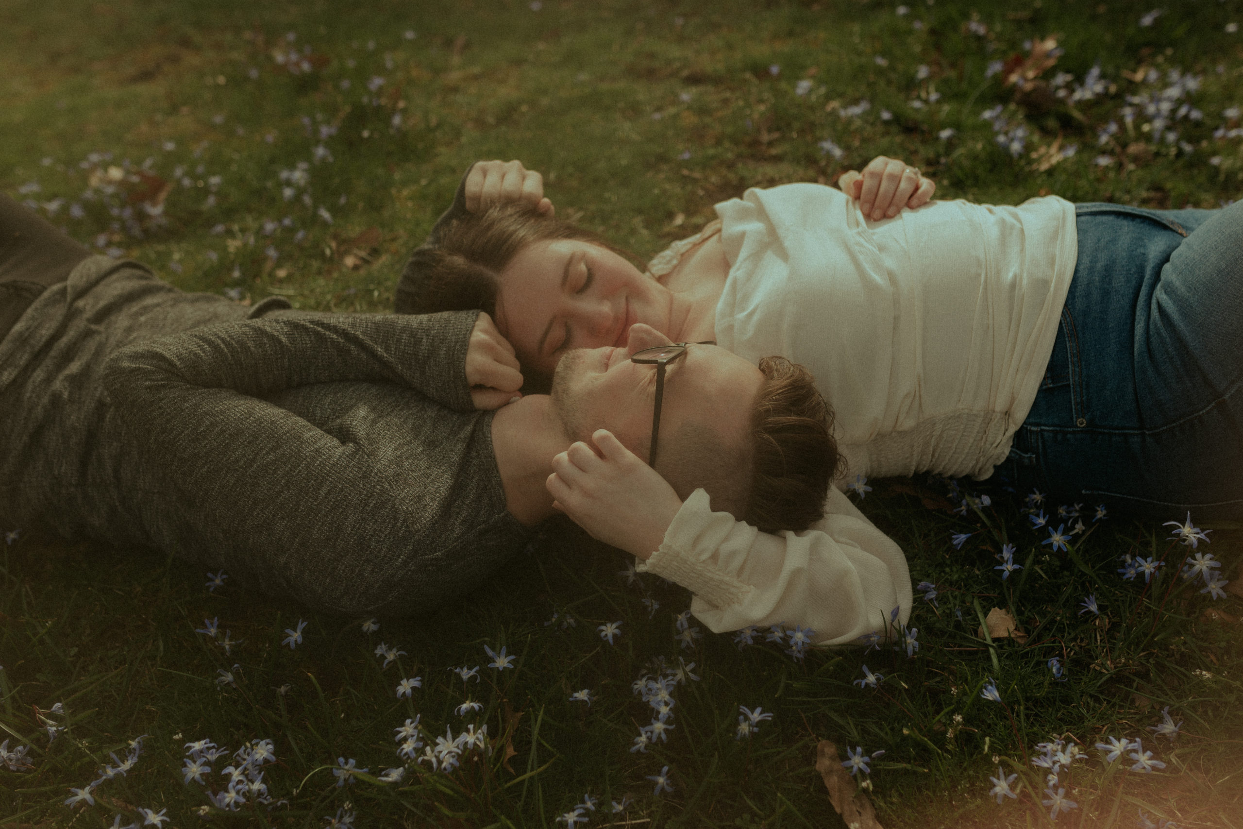 Couple Laying in Grass with Heads Together